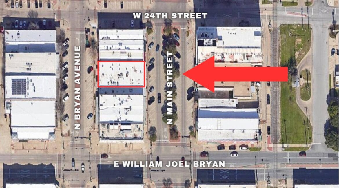 Aerial view of 212 N Main Street in Bryan, Texas, showing surrounding buildings and streets.