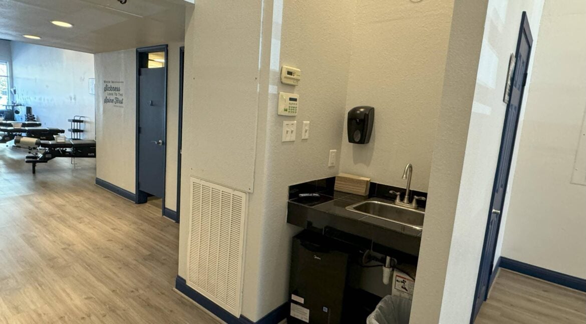 Interior view of a break area with a sink and a paper towel dispenser in Bryan, Texas.