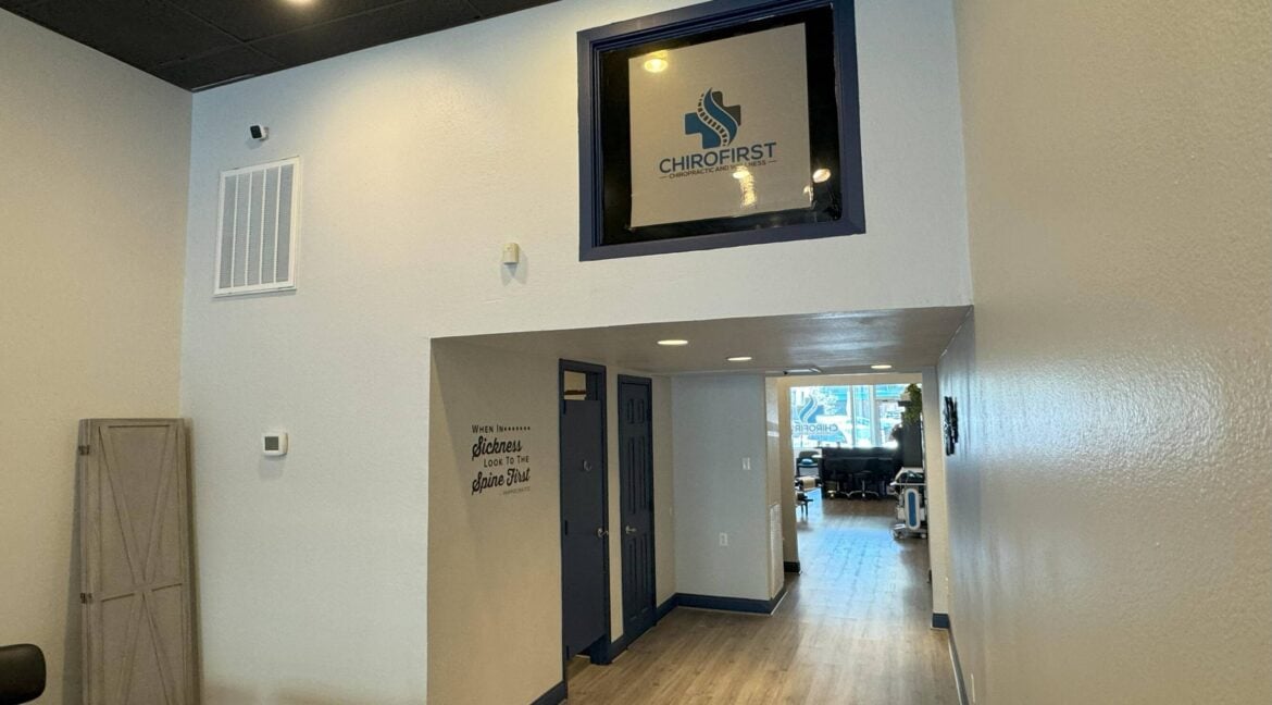 Interior view of the ChiroFirst office in Bryan, Texas with a reception area and hallway.